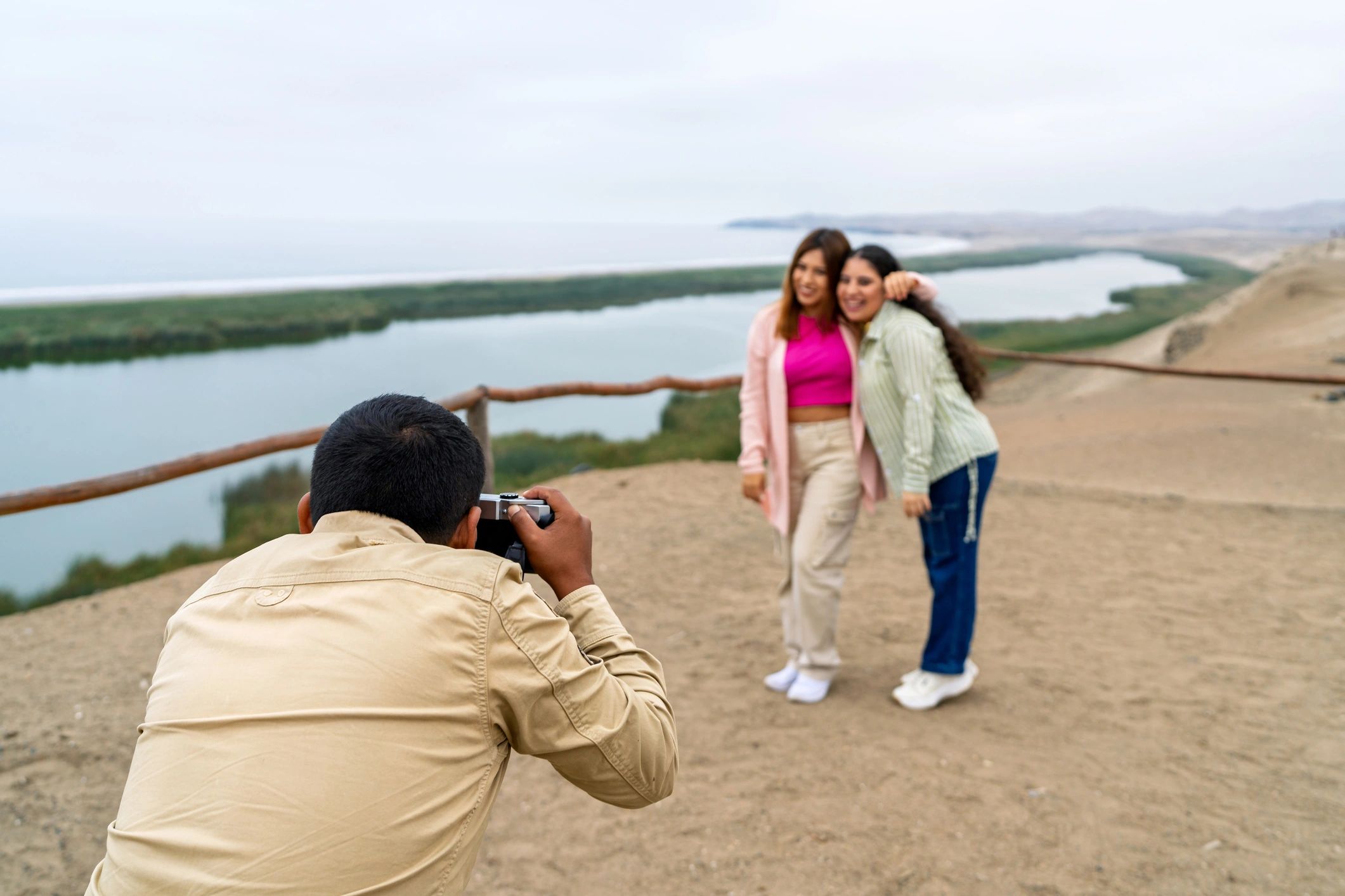 Photographer capturing travelers at a scenic overlook