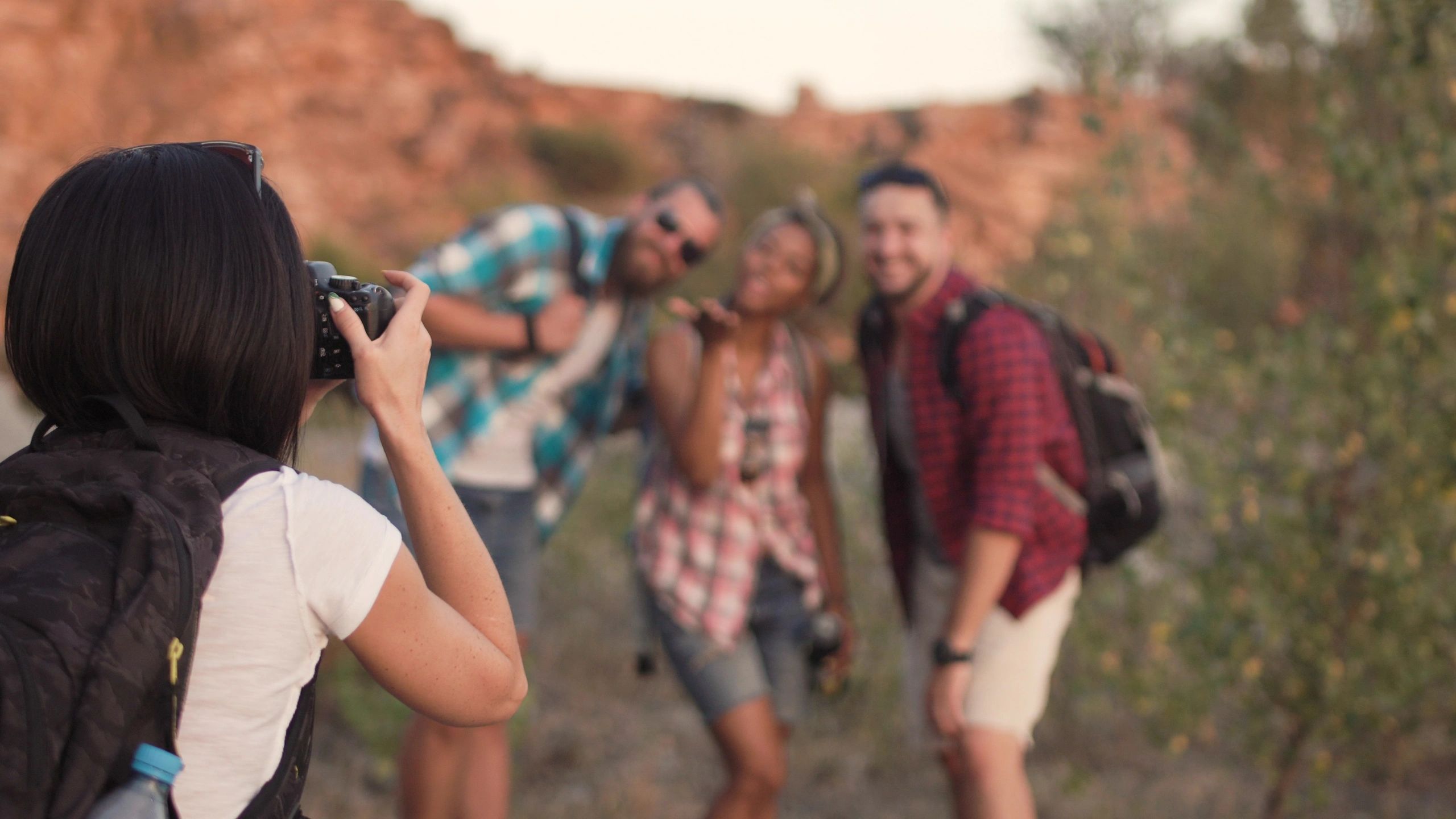 Photographer taking a picture of friends during an outdoor adventure